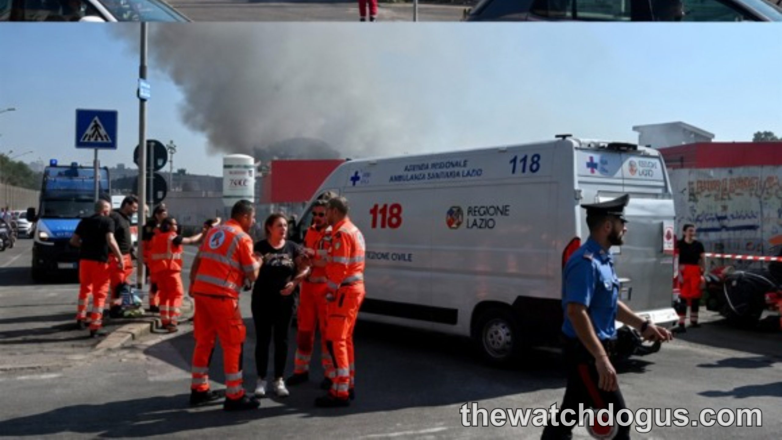 Emergency responders at scene of public incident with large fire and smoke, injured persons receiving medical attention