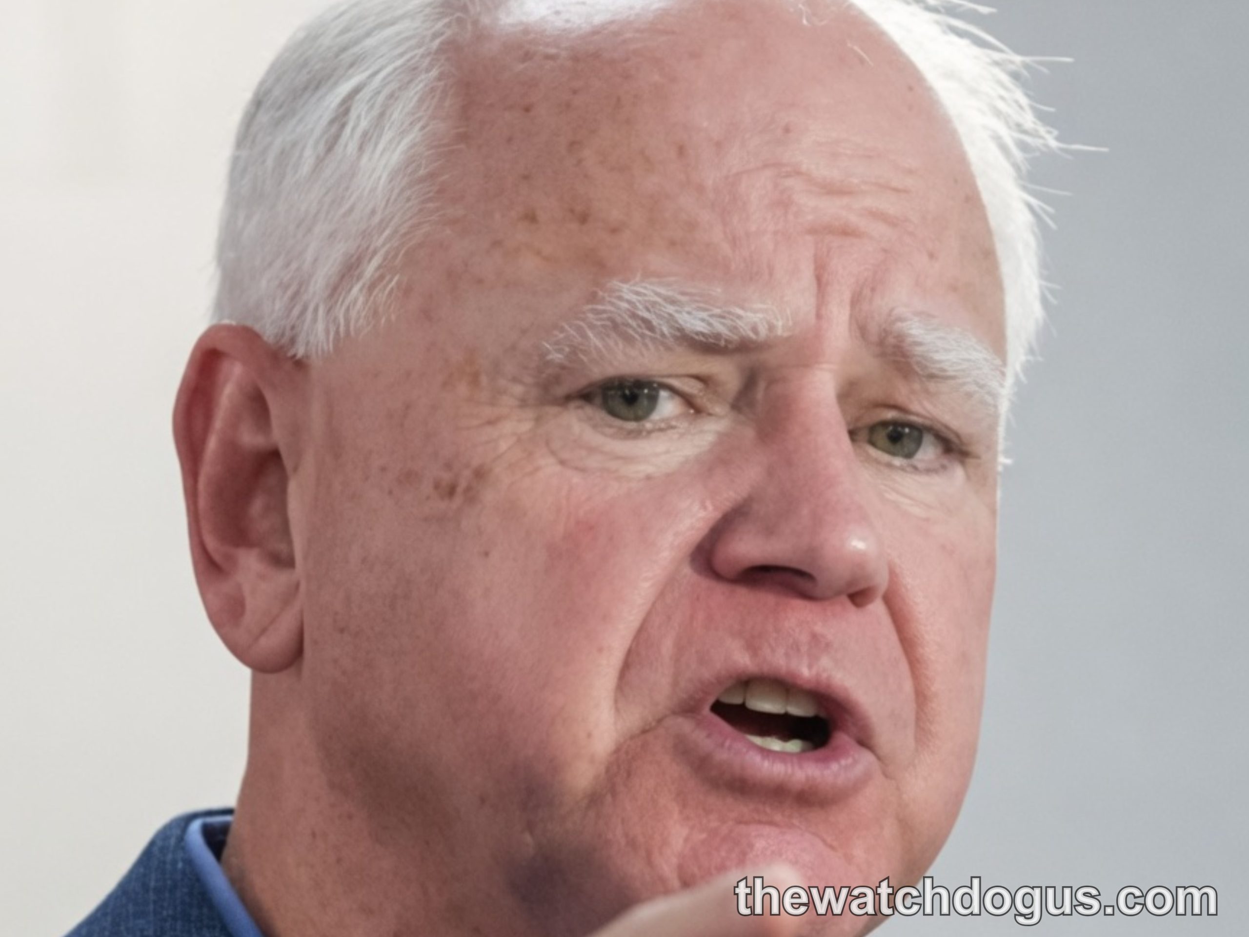 Tim Walz gesturing while speaking, demonstrating political influence and leadership in public address