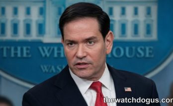 Official at White House podium discussing Iran Strait Hormuz negotiations and maritime security policy