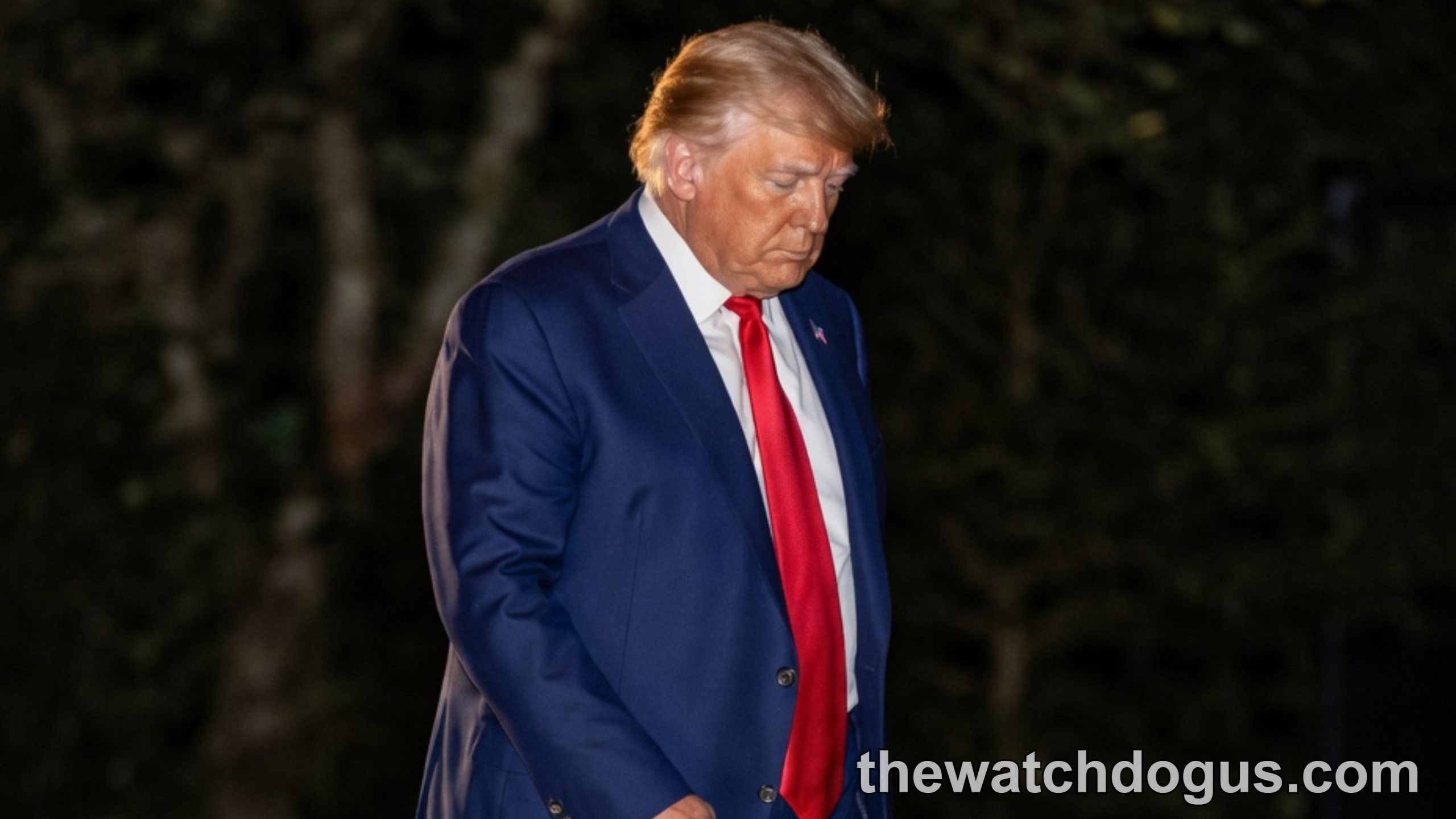 Man in navy suit and red tie walking on grass at night holding flashlight, Supreme Court TPS ruling