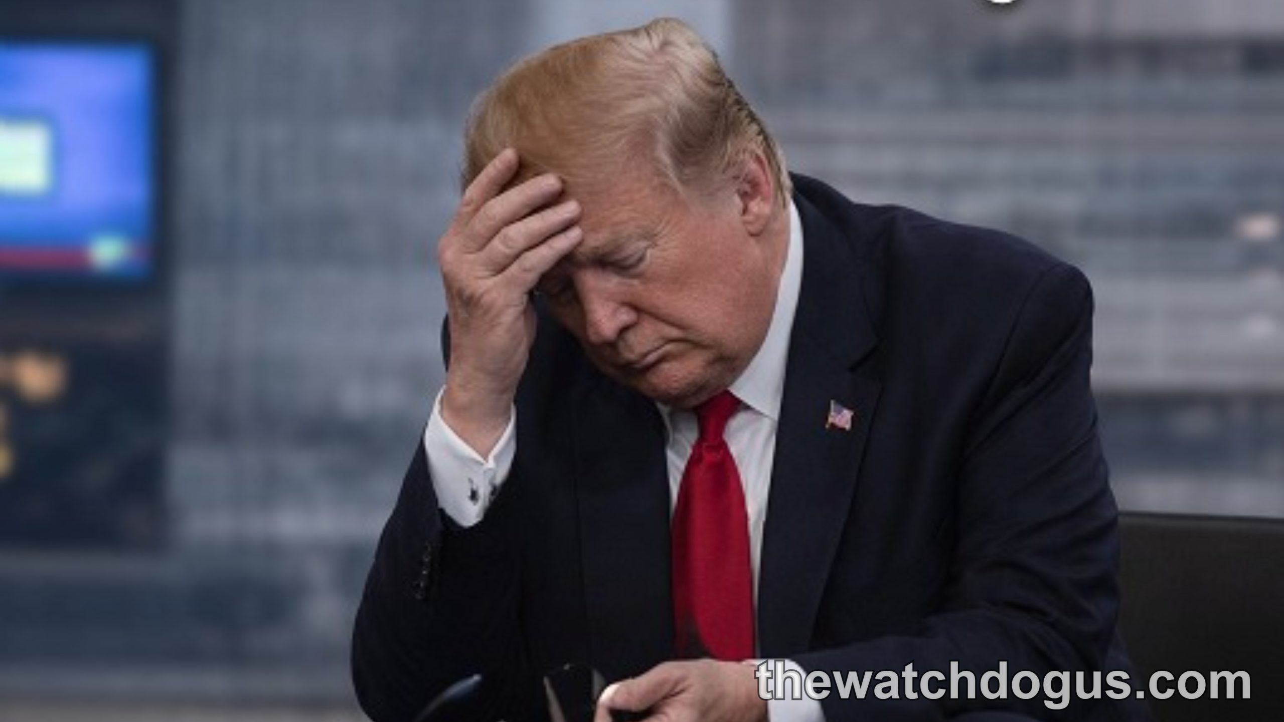Trump appears concerned during breaking news segment about Washington visit, sitting at news desk with hand to head
