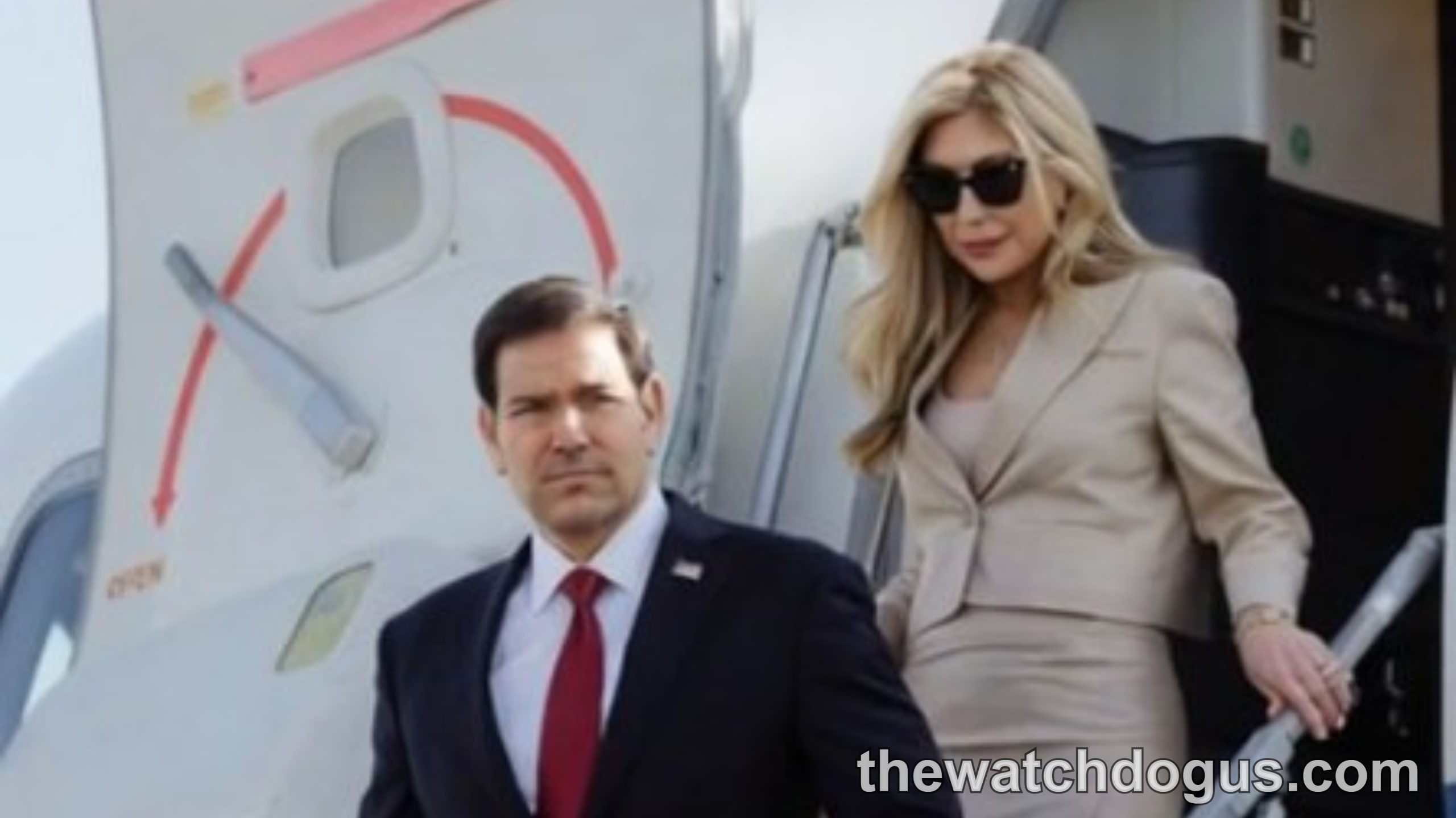 Marco Rubio in leadership role descending from official aircraft with colleague in professional attire