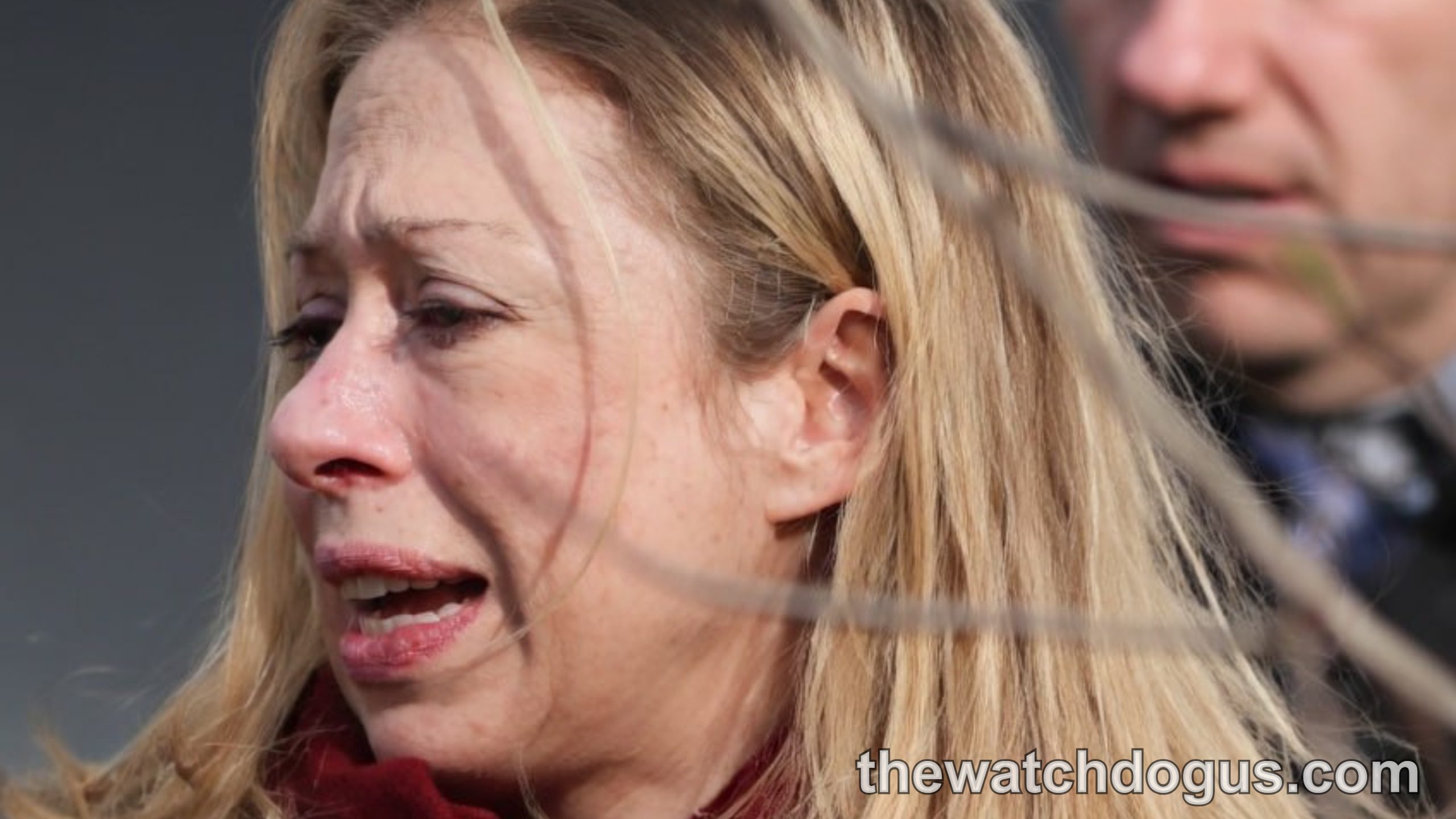 Woman speaking at Chelsea Clinton initiative event wearing red scarf and black jacket