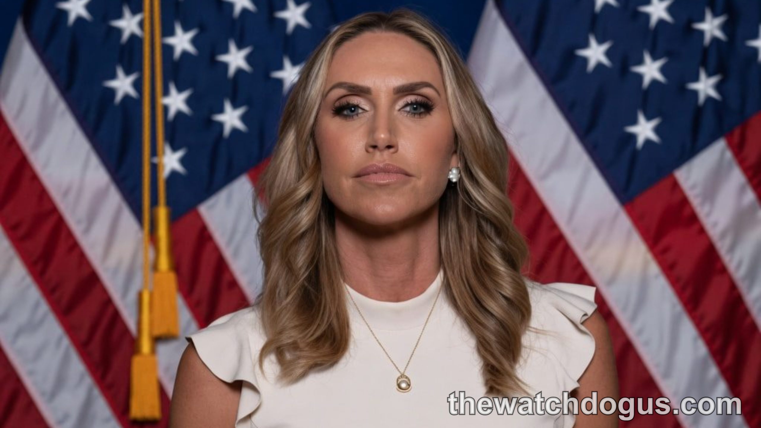Lara Trump RNC co-chair portrait with American flags background in professional white top
