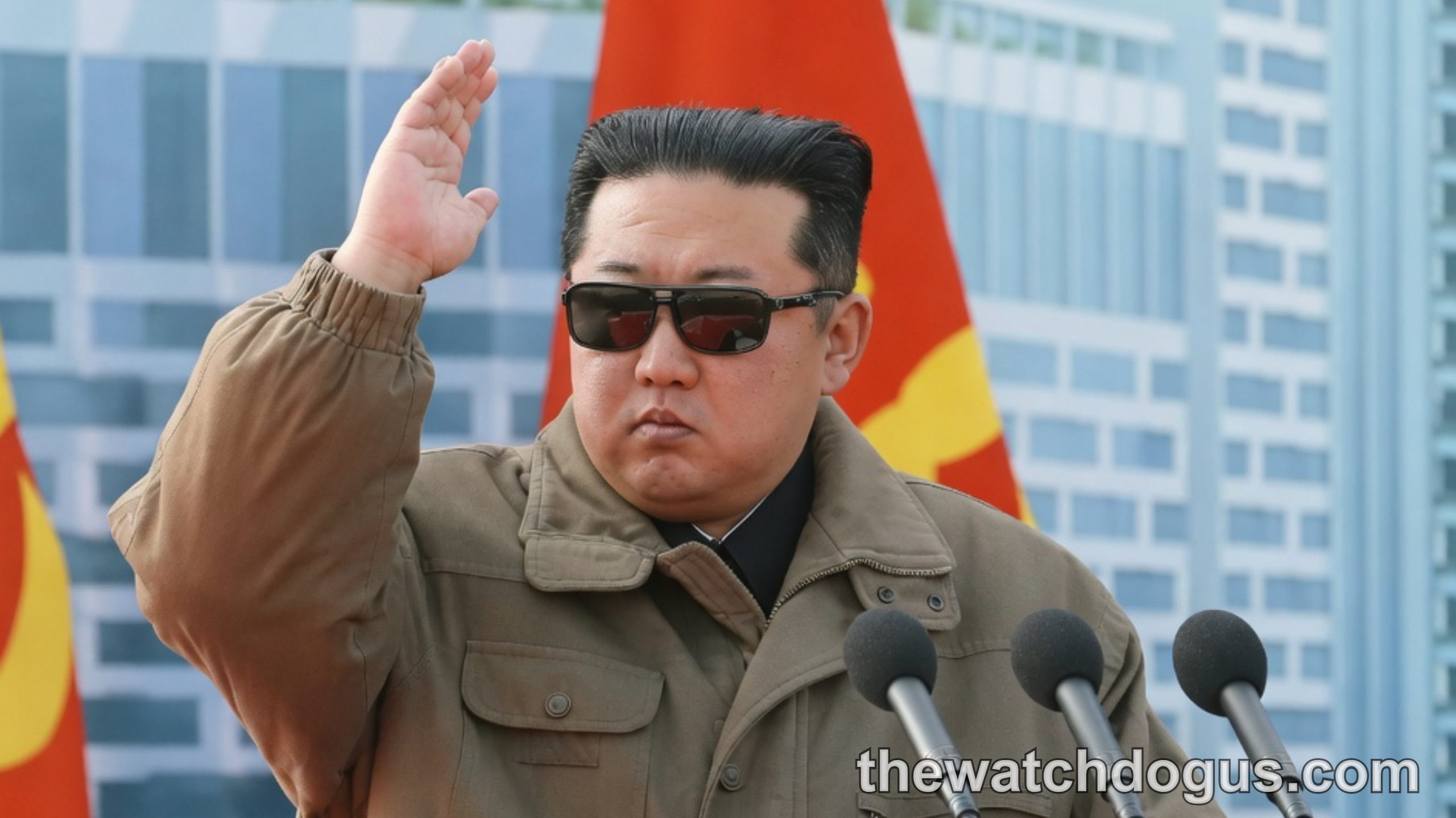 Military leader in tan jacket raises fist at podium with Korea military flag backdrop during official address