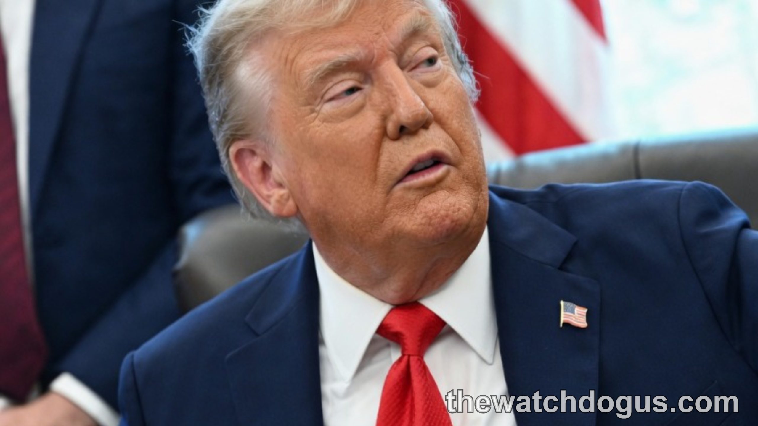 Political figure in blue suit and red tie with circled hand showing visible veins, relating to Trump venous insufficiency diagnosis