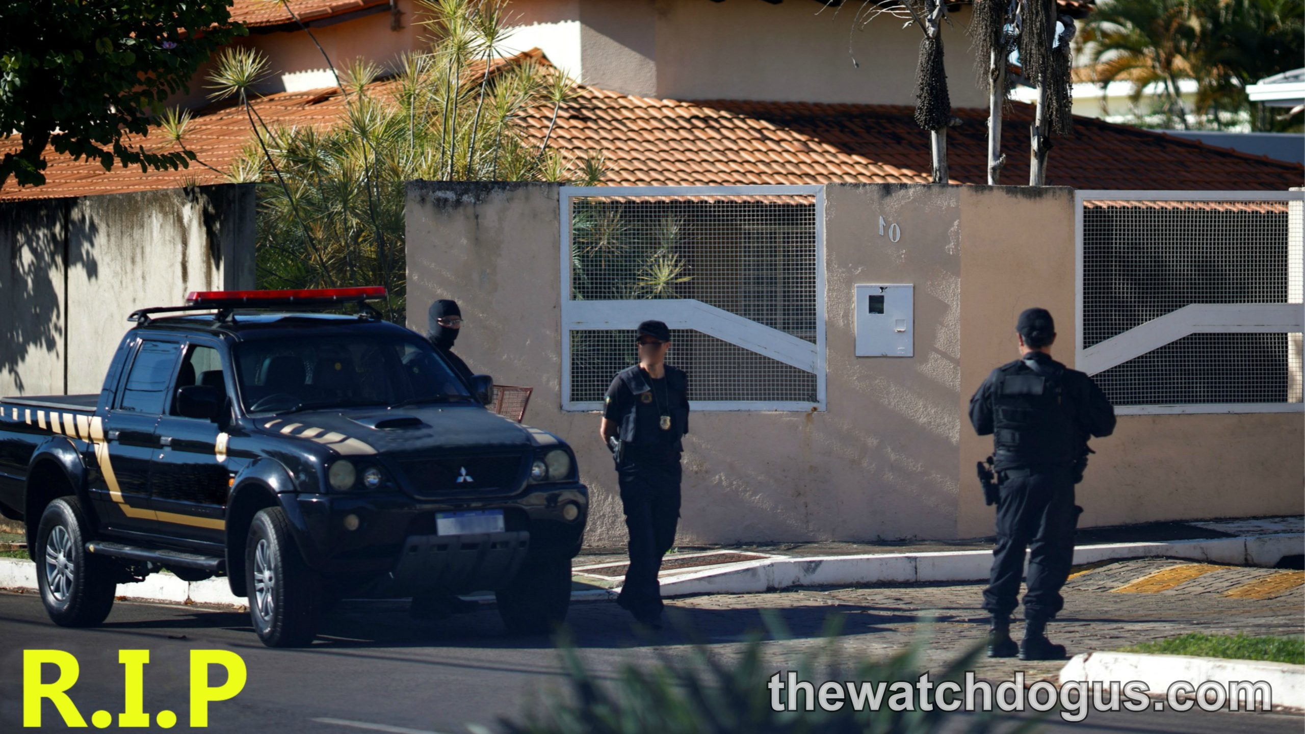 Police officers at residential property following death of beloved entertainer