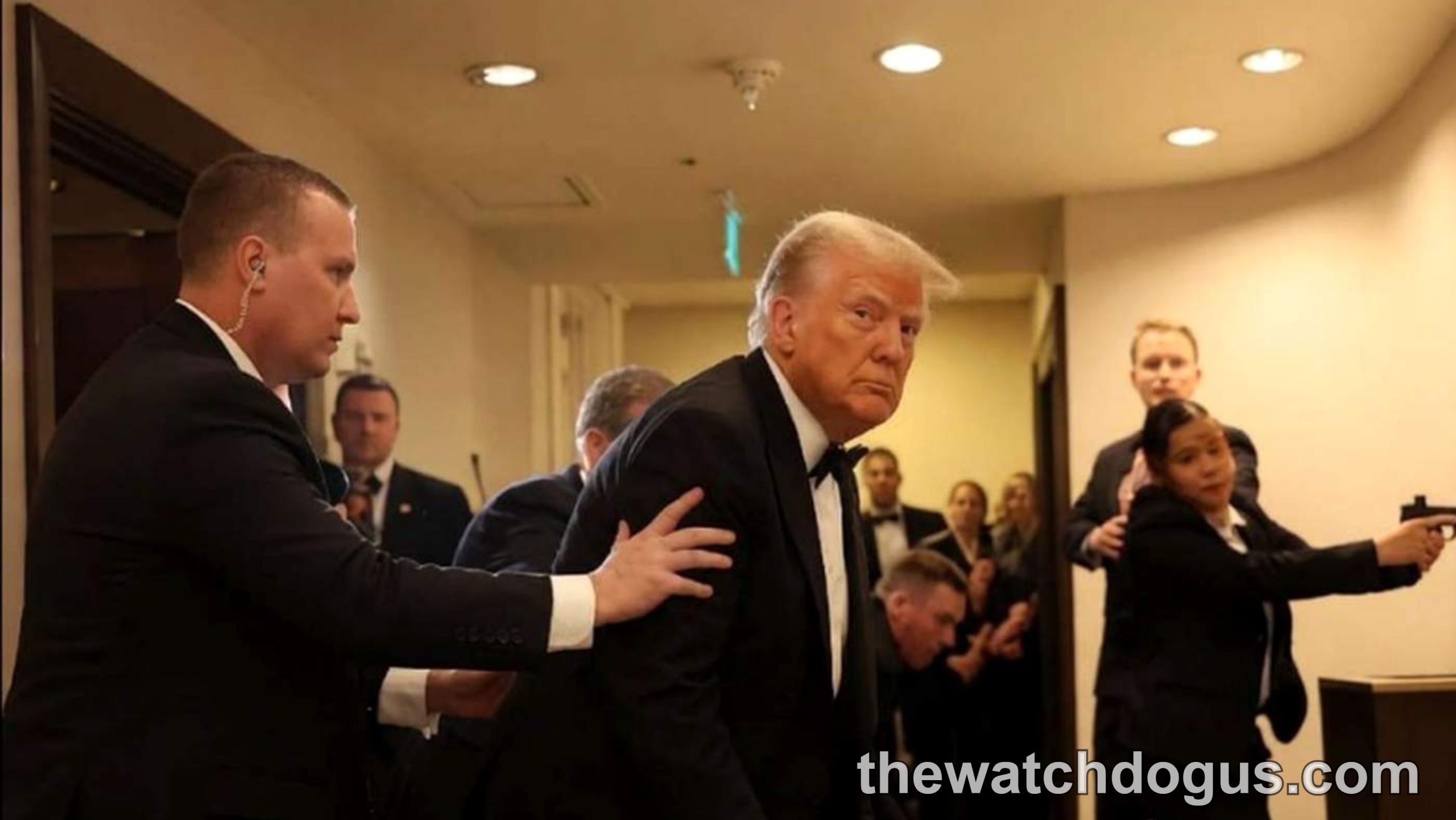 Security personnel escort a man in formal attire through a hallway during White House Correspondents dinner shooting incident