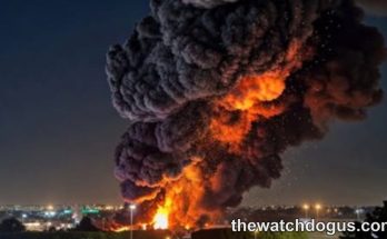 Large explosion with orange flames and dark smoke billowing over Tel Aviv explosions cityscape at night with buildings lit below
