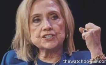 Woman speaking at podium discussing Clinton accountability and Trump during political address
