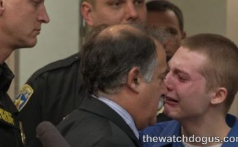 Young defendant in blue shirt speaks with attorney during juvenile sentencing hearing in courtroom with law enforcement present