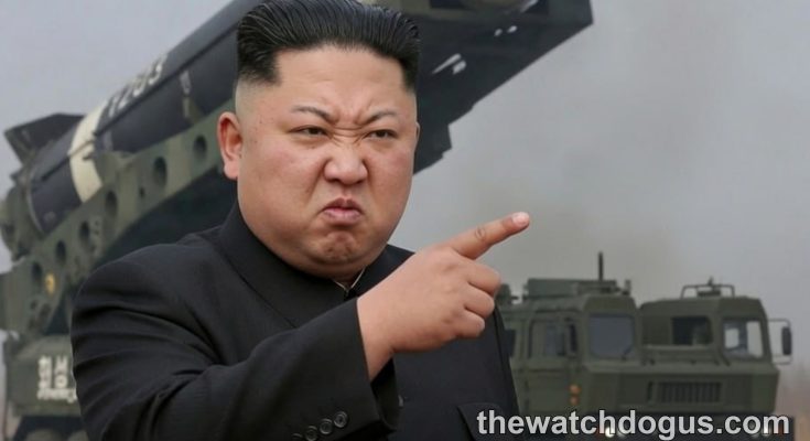 North Korea military leader makes statement gesture with missile launch display in background