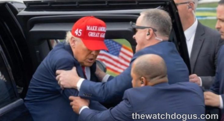 Security personnel assist man wearing red MAGA hat and American flag pin after Trump shot false claims incident