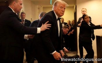 White House Correspondents Dinner security personnel guide dignitary through hallway with protective detail surrounding