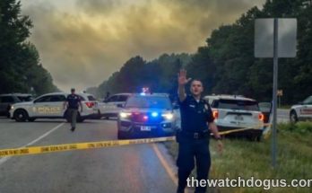 Police officers conducting a major highway security operation with emergency vehicles and crime scene tape during police operation security response